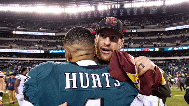 Nov 14, 2022; Philadelphia, Pennsylvania, USA; Philadelphia Eagles quarterback Jalen Hurts (1) hugs Washington Commanders injured quarterback Carson Wentz after the game at Lincoln Financial Field. Mandatory Credit: Bill Streicher-Imagn Images