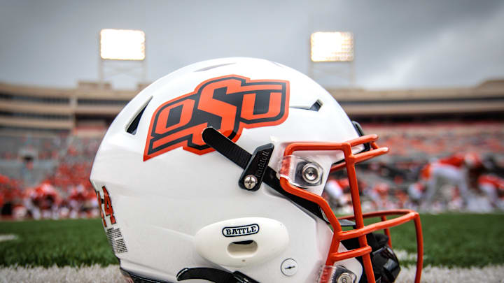 Aug 31, 2024; Stillwater, Oklahoma, USA; Oklahoma State Cowboys helmet sits on the field prior to the game against the South Dakota State Jackrabbits at Boone Pickens Stadium. Mandatory Credit: William Purnell-Imagn Images