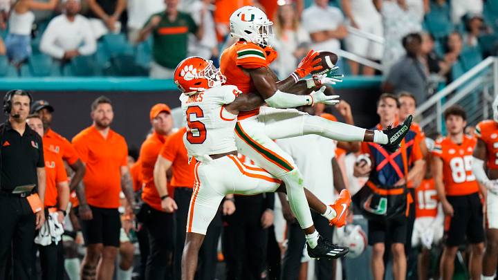 Oct 21, 2023; Miami Gardens, Florida, USA; Miami Hurricanes wide receiver Colbie Young (4) makes a catch against Clemson Tigers cornerback Sheridan Jones (6) during the fourth quarter at Hard Rock Stadium. Mandatory Credit: Rich Storry-USA TODAY Sports