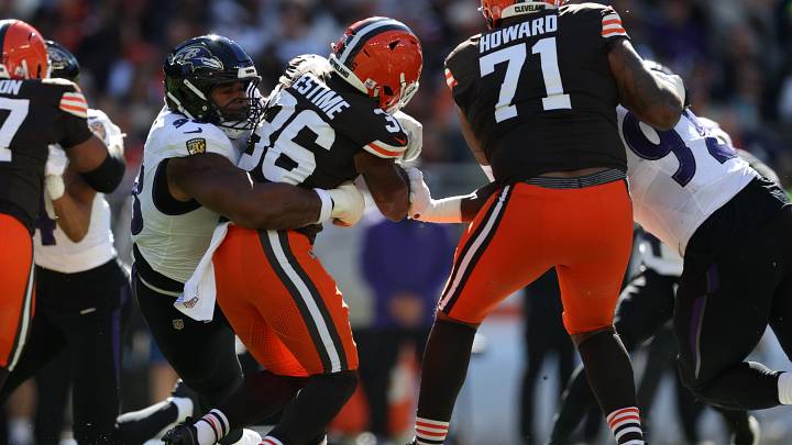 Oct 18, 2026; Cleveland, Ohio, USA;  Cleveland Browns running back Audric Estime (36) is tackled by Baltimore Ravens defensive line Travis Jones (98) as offensive tackle Tytus Howard (71) and defensive line Nnamdi Madubuike (92) defend in the first quarter at Huntington Bank Field.  Mandatory Credit: Scott Galvin-Imagn Images
