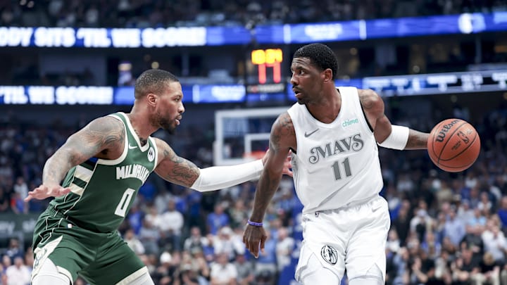 Mar 1, 2025; Dallas, Texas, USA;  Dallas Mavericks guard Kyrie Irving (11) controls the ball as Milwaukee Bucks guard Damian Lillard (0) defends during the first half at American Airlines Center. Mandatory Credit: Kevin Jairaj-Imagn Images