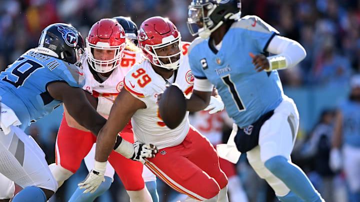 Dec 21, 2025; Nashville, Tennessee, USA; Kansas City Chiefs defensive tackle Jerry Tillery (99) chases Tennessee Titans quarterback Cam Ward (1) during the second half at Nissan Stadium. Mandatory Credit: Steve Roberts-Imagn Images