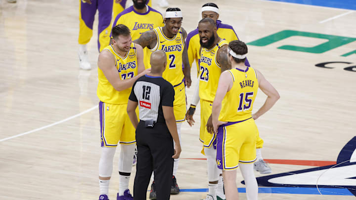 Los Angeles Lakers guard Luka Doncic (77), forward Jarred Vanderbilt (2), forward LeBron James (23), and guard Austin Reaves (15) talk to an official during a time out in the second half of a game against the Oklahoma City Thunder at Paycom Center. 
