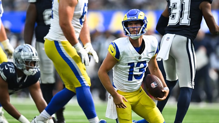 Aug 11, 2024; Inglewood, California, USA; Los Angeles Rams quarterback Stetson Bennett (13) stands up after getting sacked against the Dallas Cowboys during the fourth quarter at SoFi Stadium. Mandatory Credit: Jonathan Hui-Imagn Images