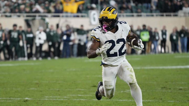 Oct 25, 2025; East Lansing, Michigan, USA; Michigan Wolverines running back Justice Haynes (22) carries the ball for a touchdown against the Michigan State Spartans during the second half at Spartan Stadium. Mandatory Credit: Brendan Mullin-Imagn Images Oct 25, 2025; East Lansing, Michigan, USA; Michigan Wolverines running back Justice Haynes (22) carries the ball for a touchdown against the Michigan State Spartans during the second half at Spartan Stadium. Mandatory Credit: Brendan Mullin-Imagn Images