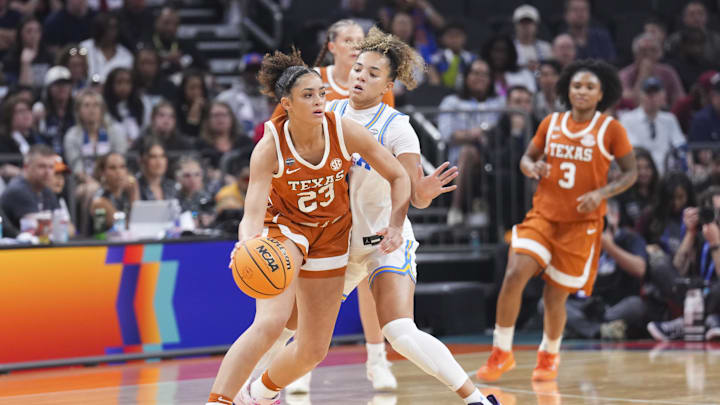 Apr 3, 2026; Phoenix, AZ, USA; Texas Longhorns guard Aaliyah Crump (23) dribbles against UCLA Bruins guard Kiki Rice (1) during the first half of a semifinal of the Final Four of the women's 2026 NCAA Tournament at Mortgage Matchup Center. Mandatory Credit: Joe Camporeale-Imagn Images