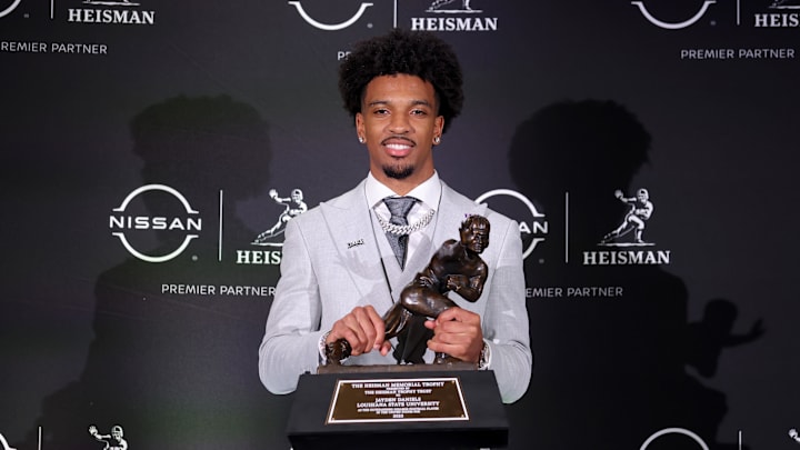 LSU Tigers quarterback Jayden Daniels poses for photos with the Heisman trophy. LSU Tigers quarterback Jayden Daniels poses for photos with the Heisman trophy.