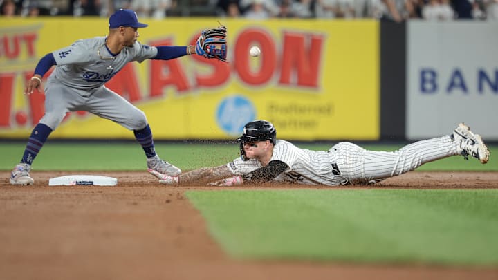 Jun 8, 2024; Bronx, New York, USA; New York Yankees left fielder Alex Verdugo (24) dives safely in to second base beating the throw to Los Angeles Dodgers shortstop Mookie Betts (50) during the fifth inning at Yankee Stadium. Mandatory Credit: Vincent Carchietta-Imagn Images