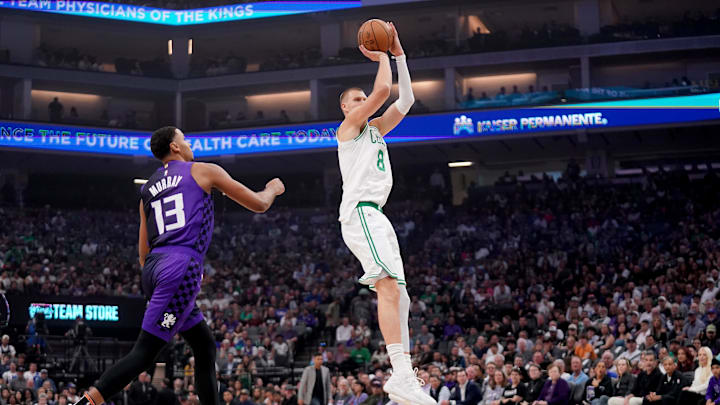 Mar 24, 2025; Sacramento, California, USA; Boston Celtics forward Kristaps Porzingis (8) shoots over Sacramento Kings forward Keegan Murray (13) in the first quarter at the Golden 1 Center. Mandatory Credit: Cary Edmondson-Imagn Images