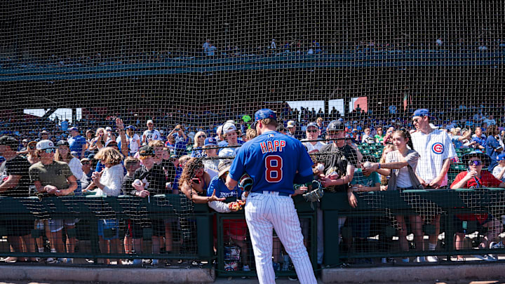 Mar 12, 2023; Mesa, Arizona, USA; Chicago Cubs outfielder Ian Happ (8) signs autographs for fans