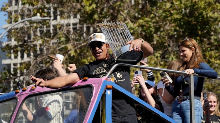 Nov 1, 2024; Los Angeles, CA, USA; Los Angeles Dodgers manager Dave Roberts (30) celebrates with the Commissioner’s Trophy during the 2024 World Series championship parade near Los Angeles City Hall. Mandatory Credit: Kirby Lee-Imagn Images