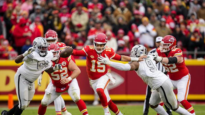 Dec 25, 2023; Kansas City, Missouri, USA; Kansas City Chiefs quarterback Patrick Mahomes (15) scrambles from Las Vegas Raiders defensive tackle Adam Butler (69) and defensive end Tyree Wilson (9) during the second half at GEHA Field at Arrowhead Stadium. Mandatory Credit: Jay Biggerstaff-USA TODAY Sports Dec 25, 2023; Kansas City, Missouri, USA; Kansas City Chiefs quarterback Patrick Mahomes (15) scrambles from Las Vegas Raiders defensive tackle Adam Butler (69) and defensive end Tyree Wilson (9) during the second half at GEHA Field at Arrowhead Stadium. Mandatory Credit: Jay Biggerstaff-USA TODAY Sports