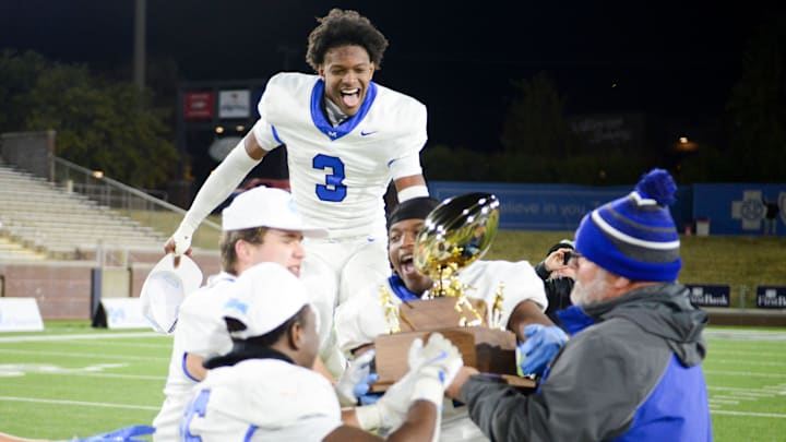 McCallie's Carson Lawrence (3) leaps in the air as players rush towards the TSSAA DII-AAA Football Championship trophy as they defeat rivals Baylor 27-21 inside Finley Stadium, Chattanooga, Tenn., on Thursday, Dec. 5, 2024. McCallie's Carson Lawrence (3) leaps in the air as players rush towards the TSSAA DII-AAA Football Championship trophy as they defeat rivals Baylor 27-21 inside Finley Stadium, Chattanooga, Tenn., on Thursday, Dec. 5, 2024.