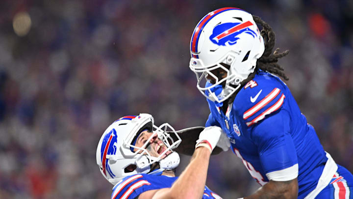 Sep 7, 2025; Orchard Park, New York, USA;  Buffalo Bills tight end Dalton Kincaid (86) celebrates a touchdown  with running back James Cook (4) during the first quarter against the Baltimore RavensI