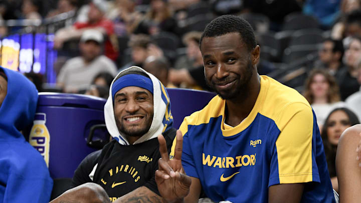 Golden State Warriors guard Gary Payton II (0) and forward Andrew Wiggins (22) gesture to a camera during the fourth quarter against the Los Angeles Lakers in their preseason game at T-Mobile Arena. Mandatory Credit: Candice Ward-Imagn Images