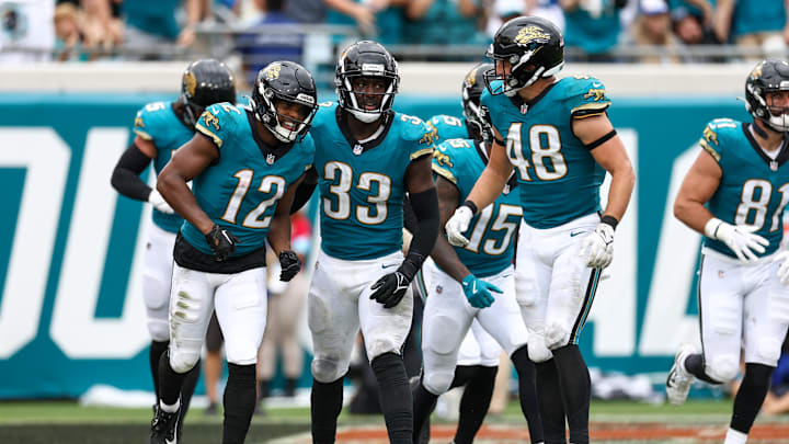 Oct 6, 2024; Jacksonville, Florida, USA; Jacksonville Jaguars wide receiver Devin Duvernay (12) and linebacker Devin Lloyd (33) celebrate after a play against the Indianapolis Colts in the third quarter at EverBank Stadium. Mandatory Credit: Nathan Ray Seebeck-Imagn Images