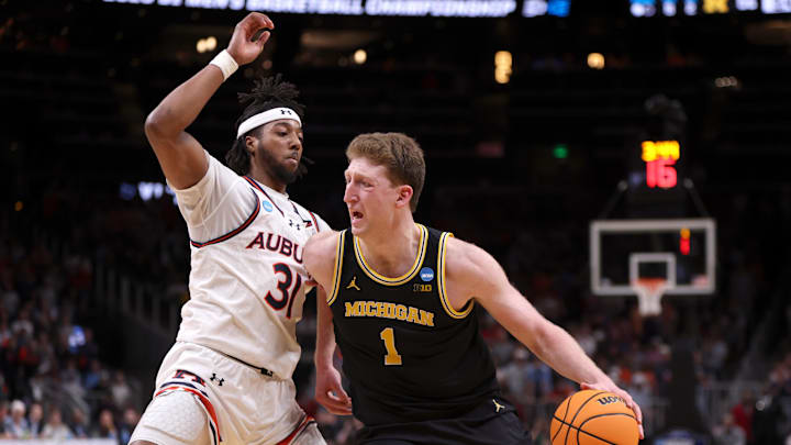 Mar 28, 2025; Atlanta, GA, USA; Michigan Wolverines center Danny Wolf (1) drives against Auburn Tigers forward Chaney Johnson (31) in the second half of a South Regional semifinal of the 2025 NCAA tournament at State Farm Arena. Mandatory Credit: Brett Davis-Imagn Images