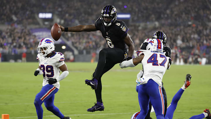 Sep 29, 2024; Baltimore, Maryland, USA; Baltimore Ravens quarterback Lamar Jackson (8) scores a touchdown as Buffalo Bills safety Damar Hamlin (3) and Bills cornerback Christian Benford (47) defend during the third quarter at M&T Bank Stadium. Mandatory Credit: Geoff Burke-Imagn Images