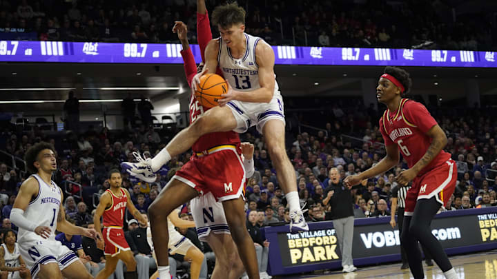 Jan 16, 2025; Evanston, Illinois, USA; Northwestern Wildcats guard Brooks Barnhizer (13) grabs a rebound against the Maryland Terrapins during the first half  at Welsh-Ryan Arena. Mandatory Credit: David Banks-Imagn Images