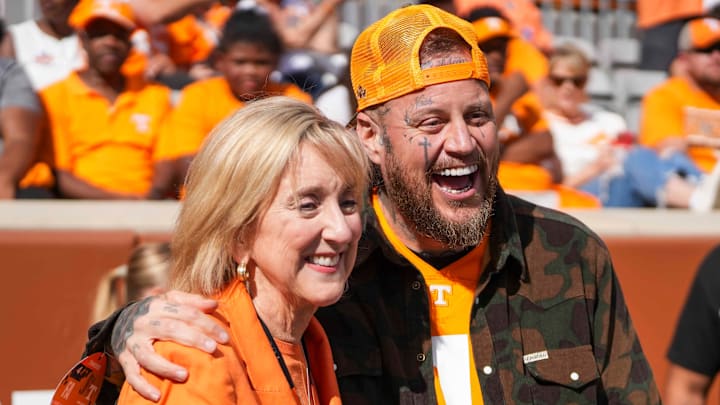 University of Tennessee, Knoxville Chancellor Donde Plowman poses for a picture with singer Jelly Roll during warm-ups before a college football game between Tennessee and Arkansas at Neyland Stadium in Knoxville, Tenn., on Oct. 11, 2025.