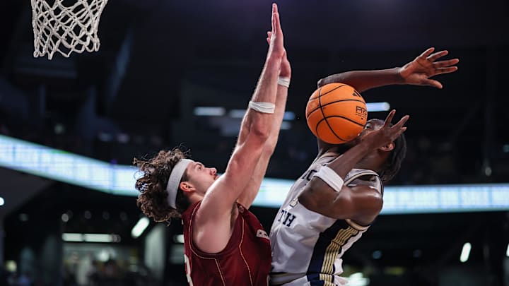 Jan 3, 2026; Atlanta, Georgia, USA; Boston College Eagles forward Boden Kapke (33) defends the shot of Georgia Tech Yellow Jackets forward Baye Ndongo (11) in the second half at McCamish Pavilion. Mandatory Credit: Brett Davis-Imagn Images