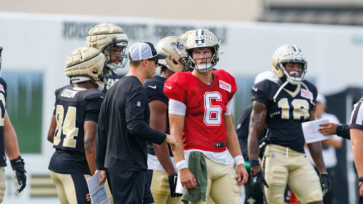 Jul 30, 2025; New Orleans, LA, USA; New Orleans Saints quarterback Tyler Shough (6) talks to New Orleans Saints quarterback coach Scott Tolzien during training camp at Ochsner Sports Performance Center. Mandatory Credit: Stephen Lew-Imagn Images Jul 30, 2025; New Orleans, LA, USA; New Orleans Saints quarterback Tyler Shough (6) talks to New Orleans Saints quarterback coach Scott Tolzien during training camp at Ochsner Sports Performance Center. Mandatory Credit: Stephen Lew-Imagn Images