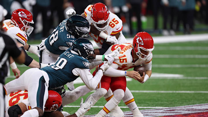 Philadelphia Eagles linebacker Jalyx Hunt (58) and linebacker Josh Sweat (19) tackle Kansas City Chiefs quarterback Patrick Mahomes.