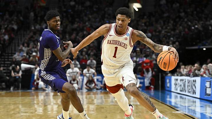 Mar 21, 2026; Portland, OR, USA; Arkansas Razorbacks guard Meleek Thomas (1) drives against High Point Panthers guard Scotty Washington (12) in the first half during a second round game of the men's 2026 NCAA Tournament at Moda Center. Mandatory Credit: Craig Strobeck-Imagn Images