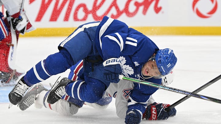 Sep 26, 2024; Toronto, Ontario, CAN;  Toronto Maple Leafs forward Max Domi (11) falls to the ice after colliding with Montreal Canadiens defenseman Jayden Strubel (47) in the third period at Scotiabank Arena. Mandatory Credit: Dan Hamilton-Imagn Images