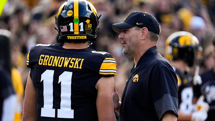 Iowa offensive coordinator Tim Lester talks to Iowa Hawkeyes quarterback Mark Gronowski (11) during warmups Aug. 30, 2025 at Kinnick Stadium in Iowa City, Iowa.