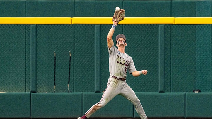 Jun 22, 2024; Omaha, NE, USA; Texas A&M Aggies left fielder Caden Sorrell (13) makes a catch for an out against the Tennessee Volunteers during the first inning at Charles Schwab Field Omaha. Mandatory Credit: Dylan Widger-Imagn Images