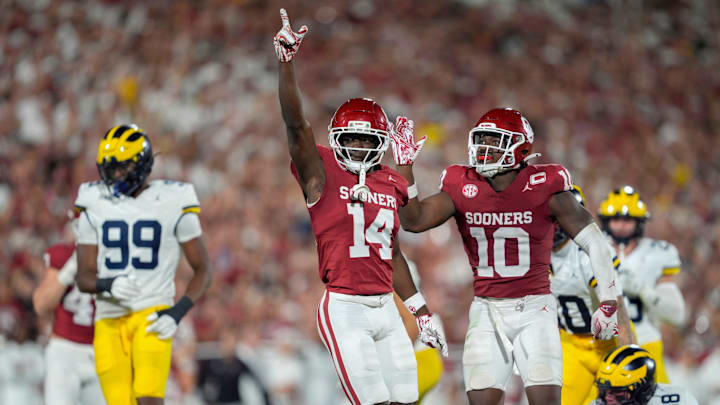 Oklahoma receiver Elijah Thomas and linebacker Kip Lewis celebrate during the Sooners' win over Michigan.