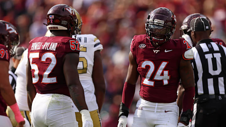 Oct 26, 2024; Blacksburg, Virginia, USA; Virginia Tech Hokies linebacker Jaden Keller (24) celebrates with defensive lineman Antwaun Powell-Ryland (52) after a play during the first quarter against the Georgia Tech Yellow Jackets at Lane Stadium. Mandatory Credit: Peter Casey-Imagn Images