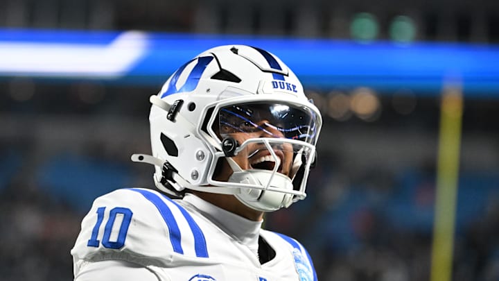 Duke Blue Devils quarterback Darian Mensah (10) celebrates after the Blue Devils score a touchdown in overtime during the  ACC Championship game at Bank of America Stadium. Mandatory Credit: Bob Donnan-Imagn Images