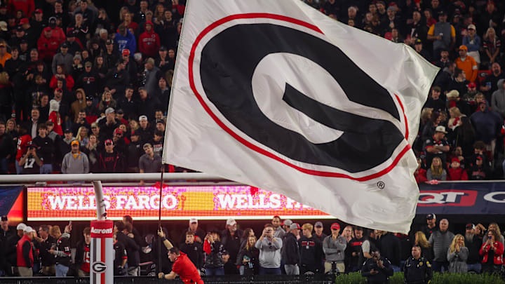 Nov 16, 2024; Athens, Georgia, USA; A Georgia Bulldogs cheerleader runs a flag against the Tennessee Volunteers in the fourth quarter at Sanford Stadium. Mandatory Credit: Brett Davis-Imagn Images
