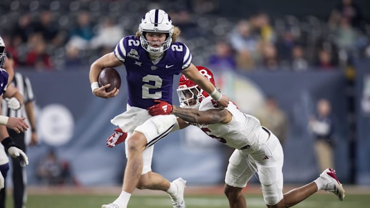 Dec 26, 2024; Phoenix, AZ, USA; Kansas State Wildcats quarterback Avery Johnson (2) runs the ball against the Rutgers Scarlet Knights during the second half of the Rate Bowl at Chase Field. Mandatory Credit: Mark J. Rebilas-Imagn Images