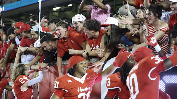 Sep 12, 2025; Houston, Texas, USA; Fans celebrate with Houston Cougars players after the game against the Colorado Buffaloes at TDECU Stadium. Sep 12, 2025; Houston, Texas, USA; Fans celebrate with Houston Cougars players after the game against the Colorado Buffaloes at TDECU Stadium.