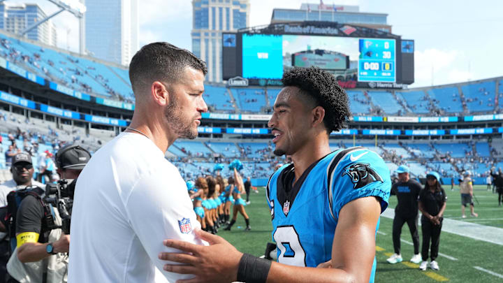 Sep 21, 2025; Charlotte, North Carolina, USA;  Carolina Panthers head coach Dave Canales with quarterback Bryce Young (9) after the game at Bank of America Stadium. Mandatory Credit: Bob Donnan-Imagn Images