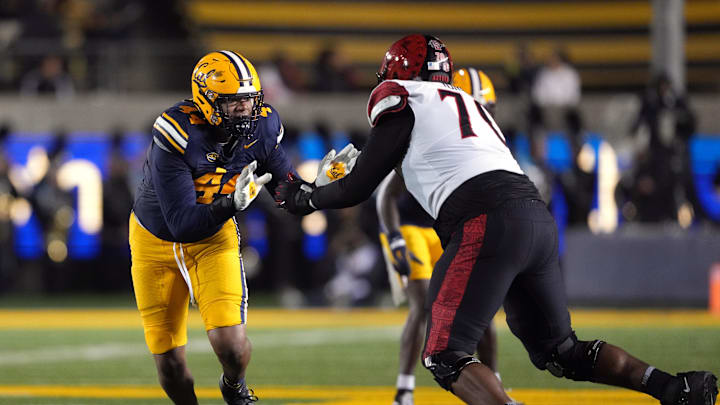 Sep 14, 2024; Berkeley, California, USA; California Golden Bears linebacker Xavier Carlton (left) rushes against San Diego State Aztecs offensive lineman Christian Jones (right) during the second quarter at California Memorial Stadium. Mandatory Credit: Darren Yamashita-Imagn Images