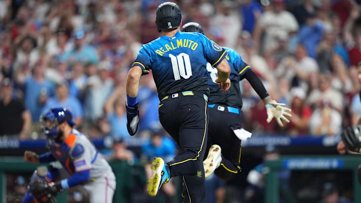 Jun 20, 2025; Philadelphia, Pennsylvania, USA; Philadelphia Phillies catcher J.T. Realmuto (10) and outfielder Nick Castellanos (8) advance home to score against the New York Mets in the seventh inning at Citizens Bank Park.