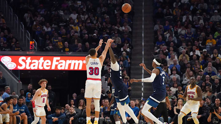 Golden State Warriors guard Stephen Curry (30) shoots a three pointer over Minnesota Timberwolves forward-center Julius Randle (30) in the second period at Chase Center. Mandatory Credit: David Gonzales-Imagn Images