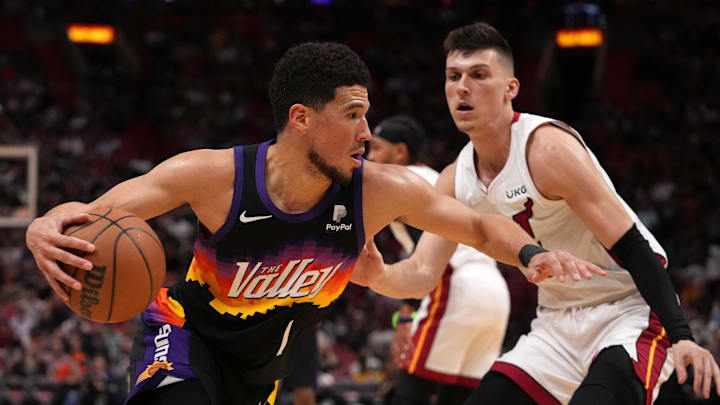 Mar 9, 2022; Miami, Florida, USA; Phoenix Suns guard Devin Booker (1) drives the ball around Miami
