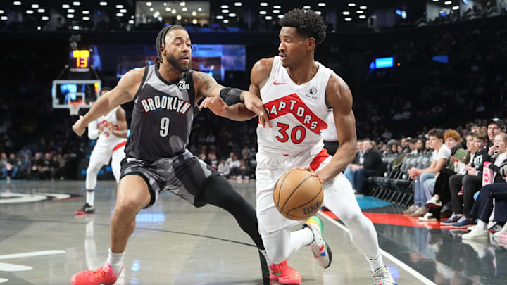 Toronto Raptors guard Ochai Agbaji dribbles the ball against Brooklyn Nets power forward Trendon Watford. Toronto Raptors guard Ochai Agbaji dribbles the ball against Brooklyn Nets power forward Trendon Watford.