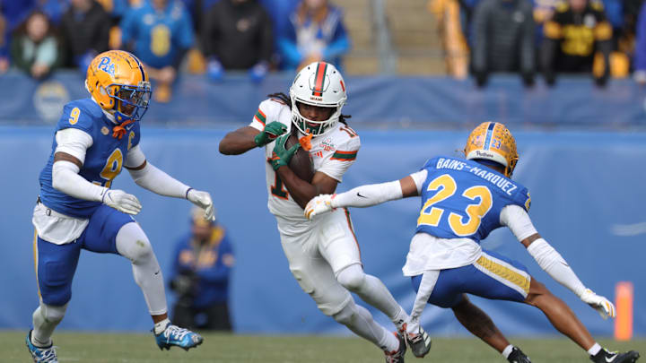 Nov 29, 2025; Pittsburgh, Pennsylvania, USA;  Miami Hurricanes wide receiver Malachi Toney (10) runs after a catch as Pittsburgh Panthers linebacker Kyle Louis (9) and safety Kavir Bains-Marquez (23) chase during the first quarter at Acrisure Stadium. Mandatory Credit: Charles LeClaire-Imagn Images