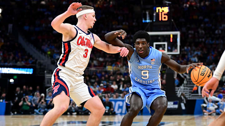 Mar 21, 2025; Milwaukee, WI, USA; North Carolina Tar Heels guard Drake Powell (9) drives against Mississippi Rebels guard Sean Pedulla (3) during the first half of a first round NCAA men’s tournament game at Fiserv Forum. 
