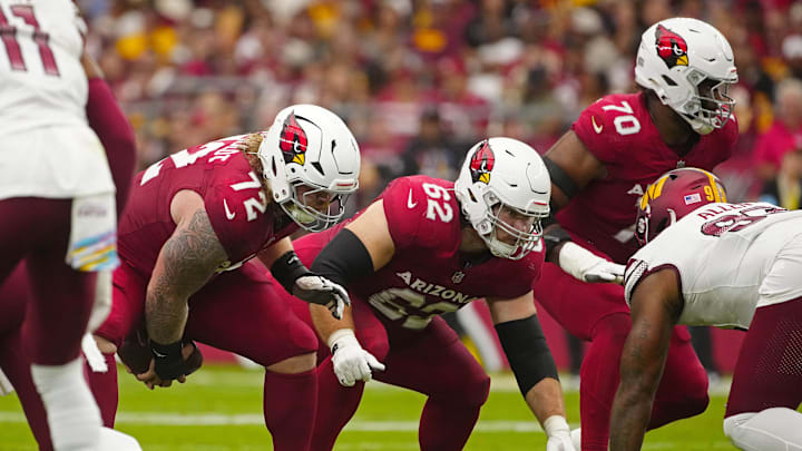Cardinals center Hjalte Froholdt (72) hikes the ball with linemen Evan Brown (62) and Paris Johnson Jr. (70) during a game at State Farm Stadium in Glendale on Sept. 29, 2024. Cardinals center Hjalte Froholdt (72) hikes the ball with linemen Evan Brown (62) and Paris Johnson Jr. (70) during a game at State Farm Stadium in Glendale on Sept. 29, 2024.