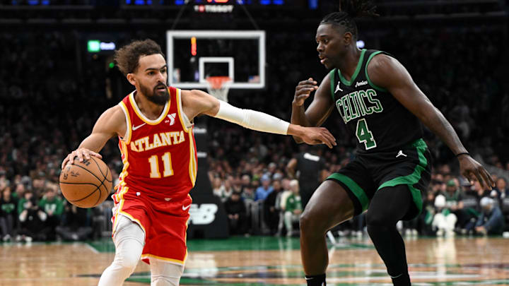 Jan 18, 2025; Boston, Massachusetts, USA; Atlanta Hawks guard Trae Young (11) drives to the basket against Boston Celtics guard Jrue Holiday (4) during the second quarter at the TD Garden. Mandatory Credit: Brian Fluharty-Imagn Images