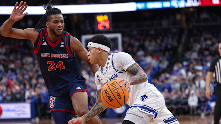 Mar 6, 2026; Newark, New Jersey, USA; Seton Hall Pirates guard Adam Clark (0) dribbles against St. John's Red Storm forward Zuby Ejiofor (24) during the second half at Prudential Center. Mandatory Credit: Vincent Carchietta-Imagn Images