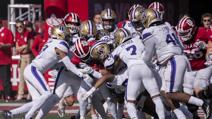 Oct 26, 2024; Bloomington, Indiana, USA; Indiana Hoosiers running back Justice Ellison (6) is tackled by multiple Washington Huskies during the third quarter at Memorial Stadium. Mandatory Credit: Jacob Musselman-Imagn Images