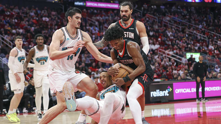 Jan 13, 2025; Houston, Texas, USA; Houston Rockets forward Amen Thompson (1) and Memphis Grizzlies guard Desmond Bane (22) battle for the ball during the second half at Toyota Center. Mandatory Credit: Troy Taormina-Imagn Images